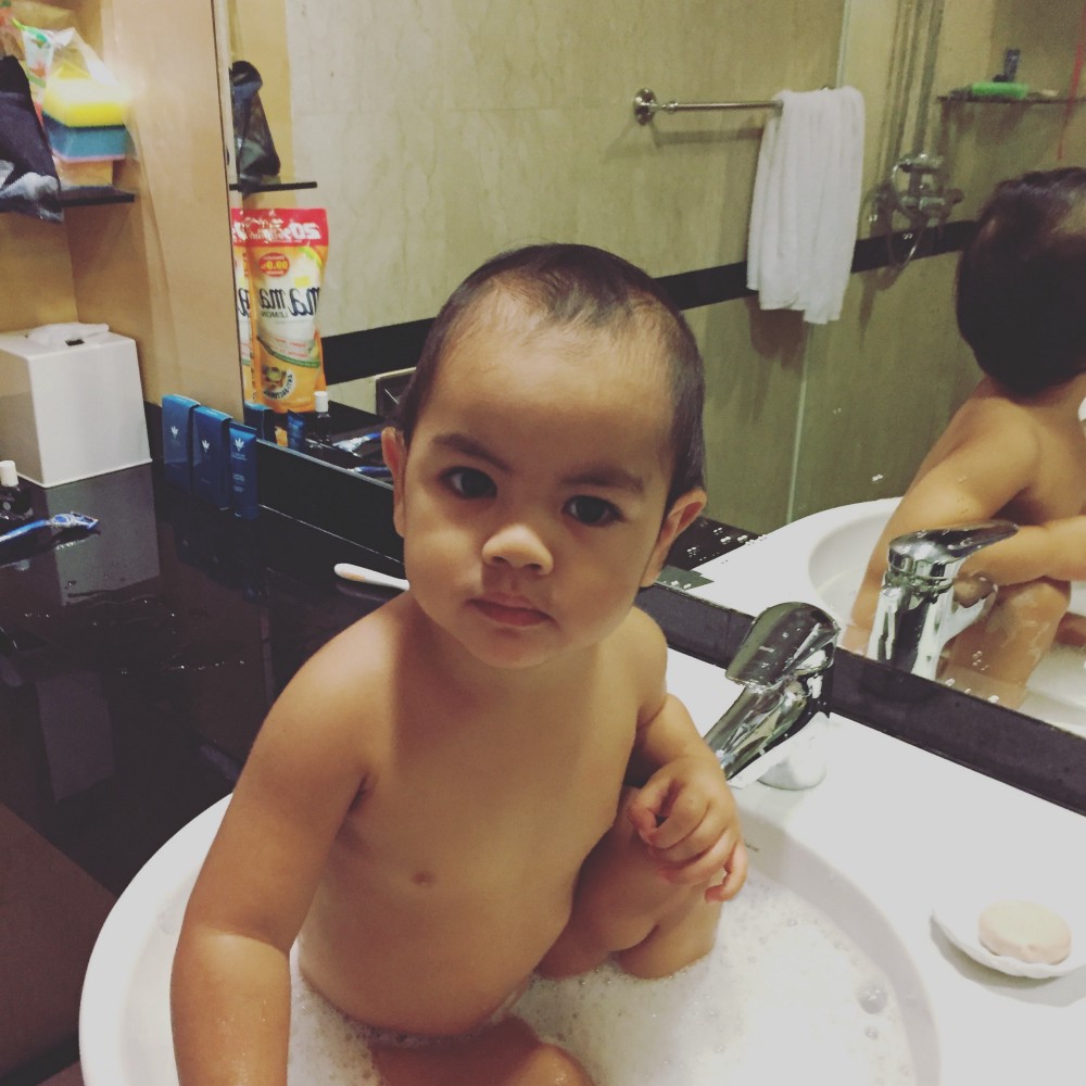 Our son having a bath in the hotel basin