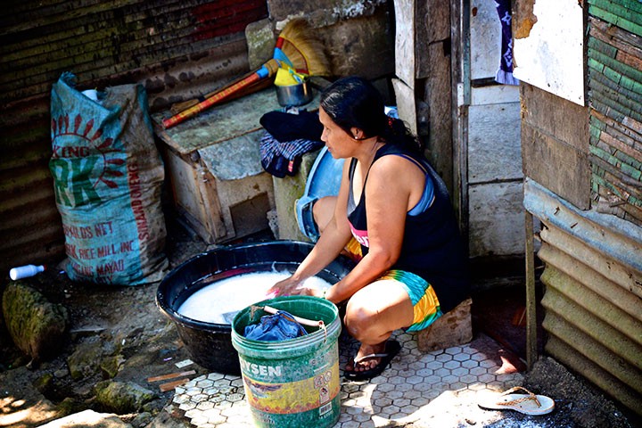 Woman washing laundry in Barangay Cotta